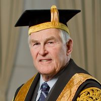 Chancellor Michael Wilson wearing his black and gold ceremonial robes and mortar board.