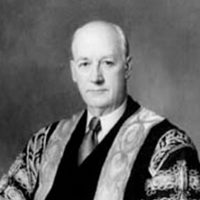 Chancellor Samuel Beatty sitting for a black and white portrait in his ceremonial robes and tie.